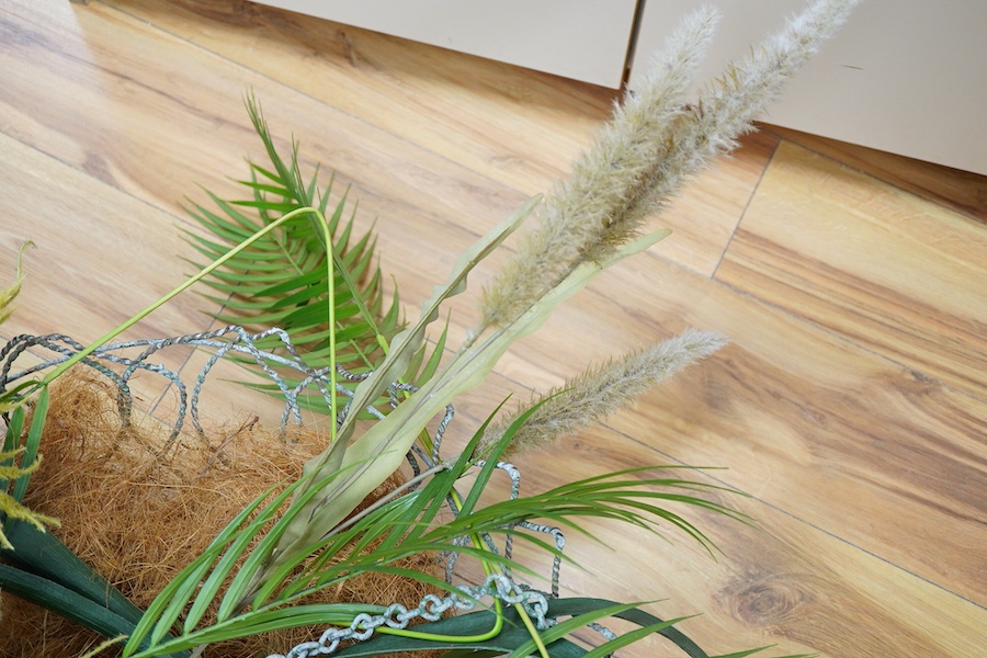 A large wire work hanging basket and decorative faux foliage, 50cm wide